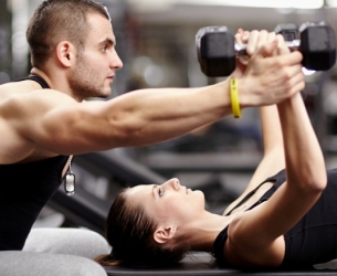 woman lifting weights with male personal trainer - Train Hard Fitness 8180 Oswego Rd. Liverpool, NY 13090 315-409-4764
